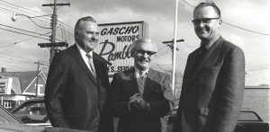 gascho team standing in front of gascho motors sign