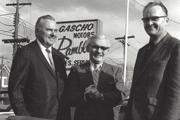 gascho team standing in front of gascho motors sign